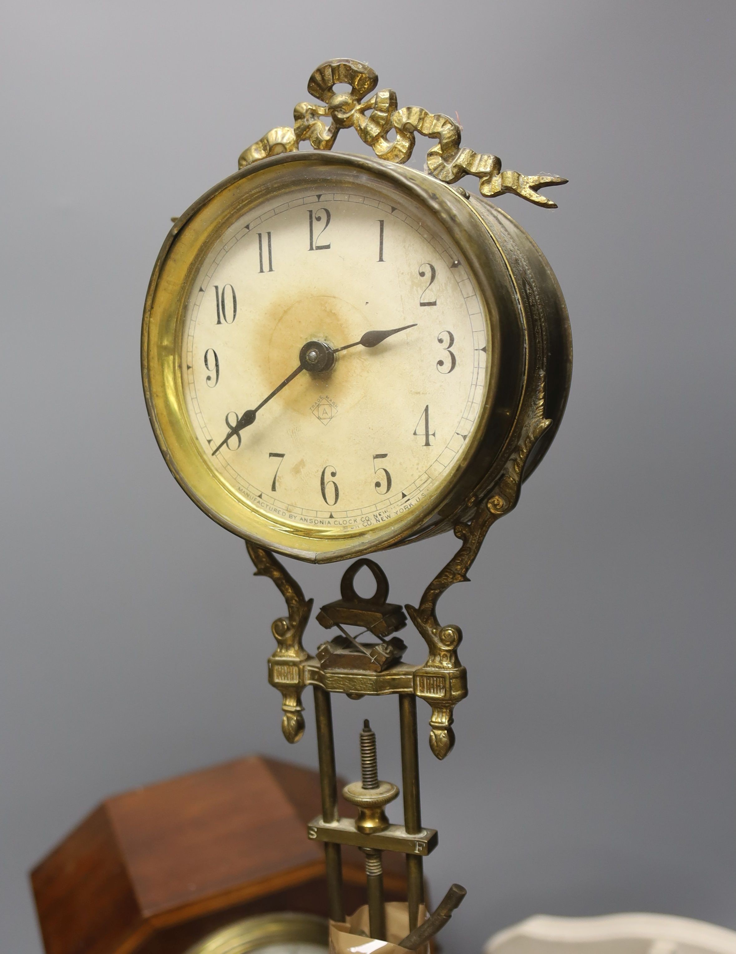 An incomplete late 19th century brass mystery timepiece, a painted wall bracket and an inlaid mahogany mantel clock